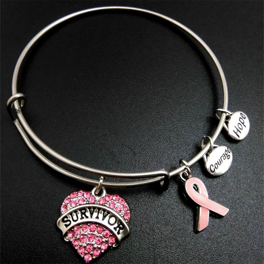 herzensmut – charm-armband mit pinker schleife & survivor-herz - lunastein