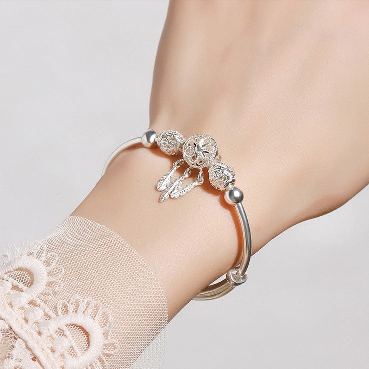 traumfängerlicht – charm-armband in silberoptik mit federanhängern - lunastein