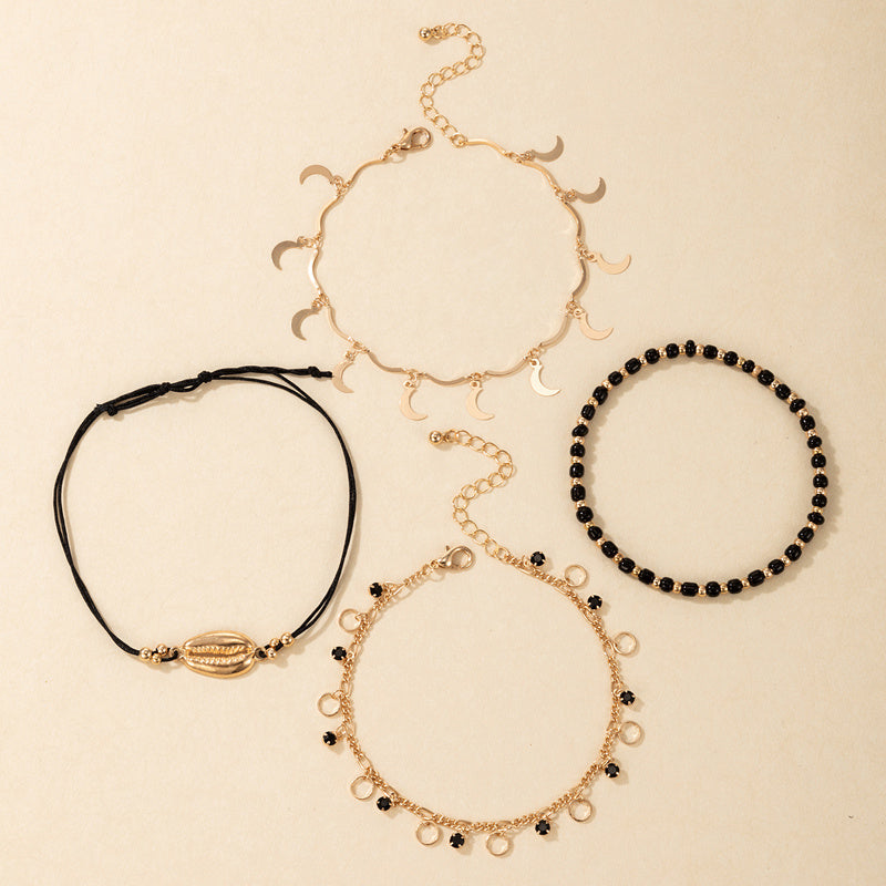 luna coast – 4-teiliges fußkettchen-set in gold & schwarz - lunastein - schmuck