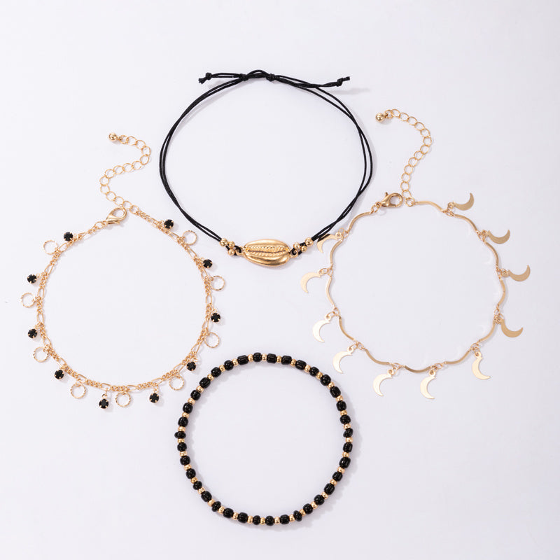 luna coast – 4-teiliges fußkettchen-set in gold & schwarz - lunastein - schmuck
