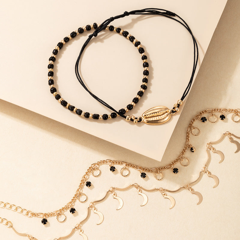 luna coast – 4-teiliges fußkettchen-set in gold & schwarz - lunastein - schmuck