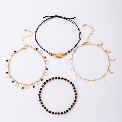 Luna Coast – 4-teiliges Fußkettchen-Set in Gold & Schwarz - Lunastein - Schmuck